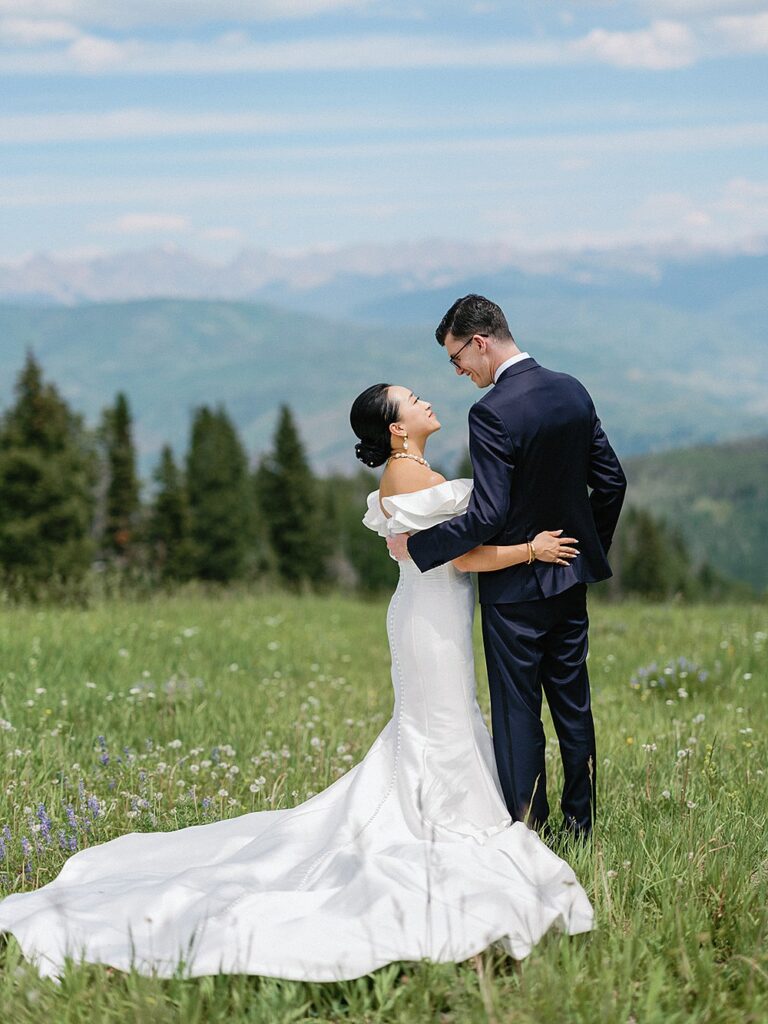 bride and groom in wildflower field at Ritz Carlton Bachelor Gulch wedding venue